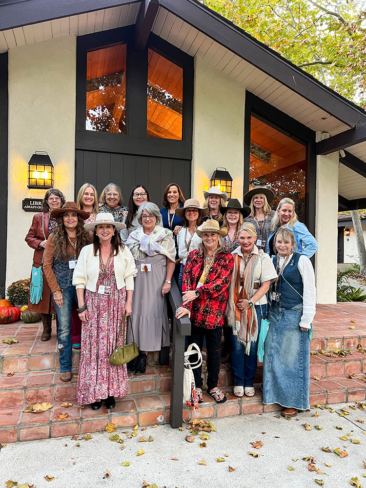 The women having a group shot on the ranch at the retreat