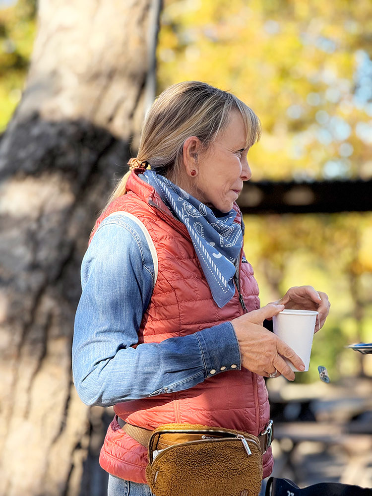 Janet holding a cup during cowboy breakfast at the wellness retreat